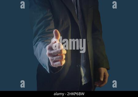 A man in a suit shows a great sign. A sign of success and good luck. A sign of a job well done. Front view. Stock Photo