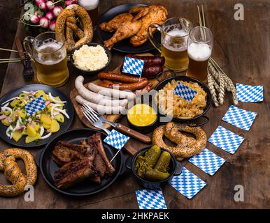 Oktoberfest dishes with beer, pretzel and sausage Stock Photo