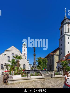 Lindau in Lake Constance, Bavaria, Germany, Europe: Bustling scene in front of Neptune's Fountain in the middle between St. Stephen's and the Minster. Stock Photo
