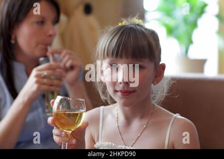 The teen poses with glass of lemonade at the restaurant Stock Photo