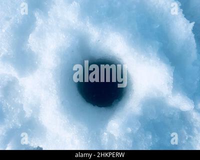 Fishing in the winter. Fishing through a hole in ice Stock Photo