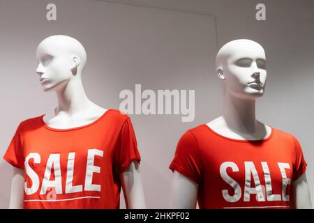 mannequins in red t-shirts with the inscription discount. Stock Photo