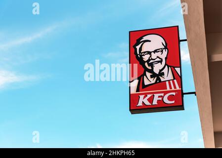 SABAH, MALAYSIA - 23 MAY, 2019: KFC Logo on advertising signboard against blue sky. KFC is an American fast food restaurant chain. Stock Photo