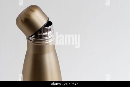 Open cap of metal thermos close-up on white background Stock Photo