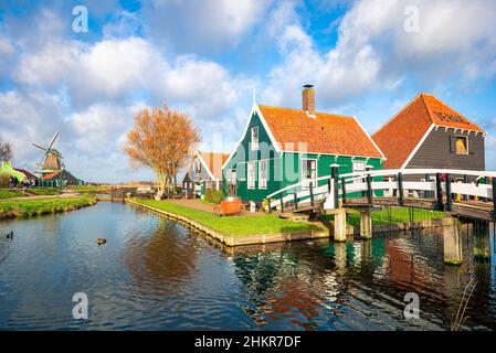 Picturesque view of ancient wooden Dutch houses along the waterside in Zaanse Schans, Netherlands. Stock Photo