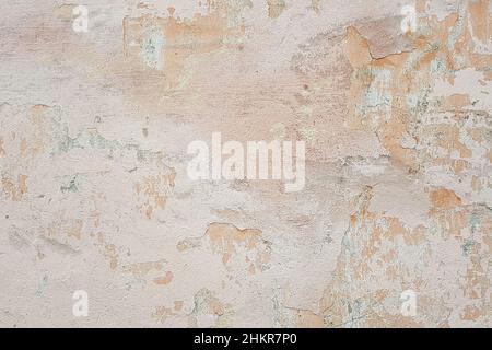 surface of old shabby wall with falling off plaster, beige-pink shades, background, texture Stock Photo