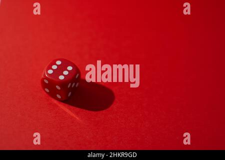 Red dice on a red background Stock Photo