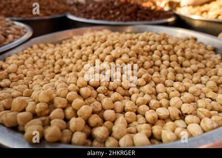 hazelnuts in bowl at street market. Stock Photo
