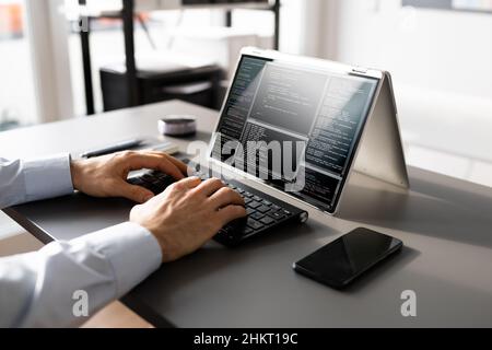 Computer Programmer Writing Program Code On Computer In Office Stock Photo