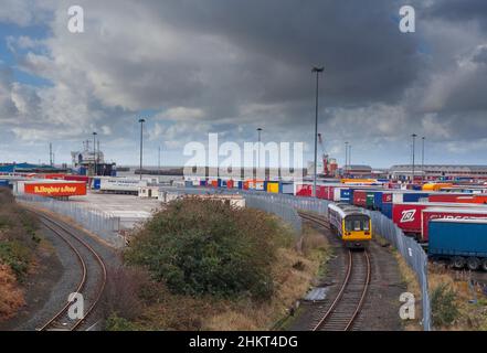 The once daily passenger train to Heysham port departs the port to Leeds formed of a Northern Rail class 142  pacer train Stock Photo