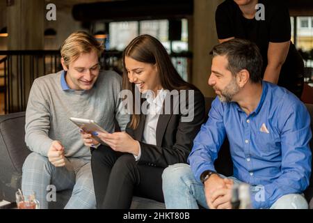 Four business people are organizing and making the project for the company while smiling Stock Photo