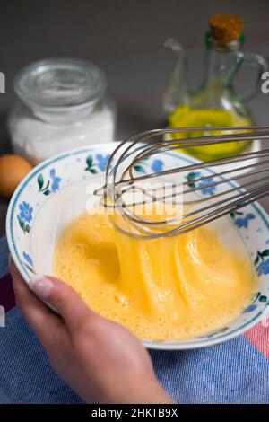 detail whisk eggs in a white bowl with a whisk Stock Photo