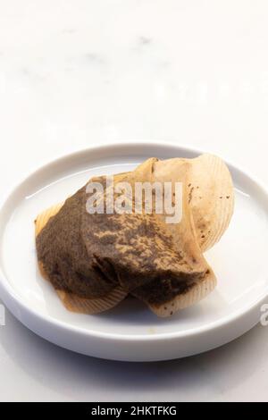 Used Teabag in a small dish on a kitchen counter Stock Photo