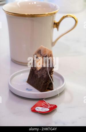 Used Teabag in a small dish on a kitchen counter Stock Photo