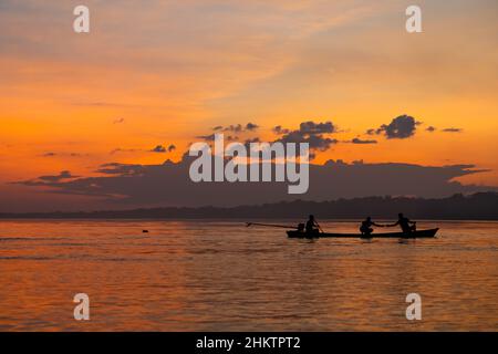 sunset with dolphin in silhouette on the amazon river in Puerto Nariño, Colombia Stock Photo