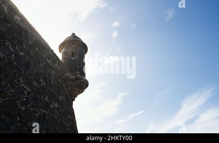 Low angle shot of El Morro historical castle and a blue sky on a sunny day Stock Photo