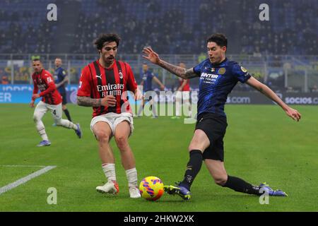 Milan, Italy, 5th February 2022. Alessandro Bastoni of FC Internazionale crosses the ball as Sandro Tonali of AC Milan closes in during the Serie A match at Giuseppe Meazza, Milan. Picture credit should read: Jonathan Moscrop / Sportimage Stock Photo