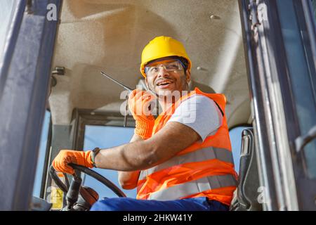 Worker in safety equipment working at heavy industry plant Stock Photo