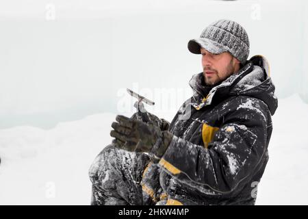 Worker with a chisel in his hand at a construction site Stock Photo