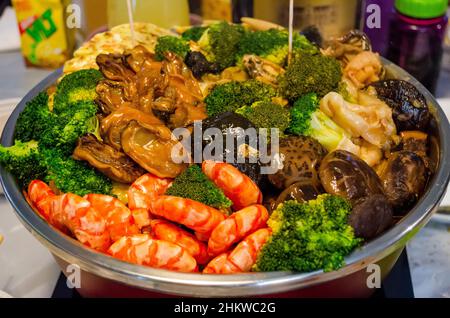 The famous Chinese New Year mixed Drunken pot,  a traditional food eaten each chinese new year by Chinese families, Hong Kong, China. Stock Photo