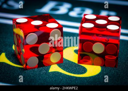 A macro photograph of professional casino-style dice sitting on the pass section of a craps table.