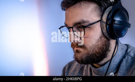 Portrait of a man with glasses and professional headphones. Stock Photo