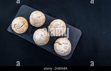 Appetizing Shu cakes on a black background. Stock Photo