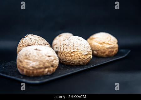 Appetizing Shu cakes on a black background. Stock Photo