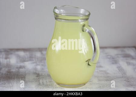 Liquid whey that remains after formation of curds in jar on the white background Stock Photo