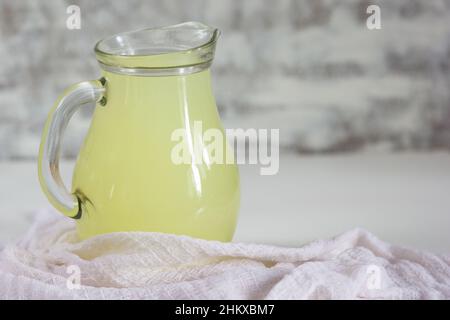 Liquid whey that remains after formation of curds in jar on the white background Stock Photo