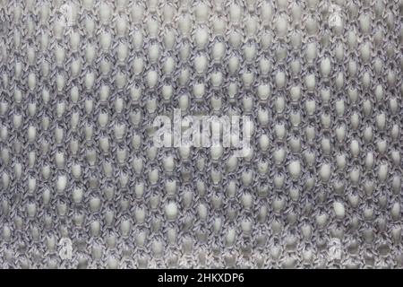 background made from honeycomb mesh lace knitting pattern made from the gray gradient yarn Stock Photo