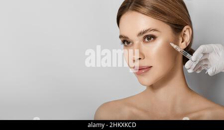 beauty injections into beautiful face. Smoothing of mimic wrinkles around eyes using beauty injections with fillers, procedure biorevitalization Stock Photo