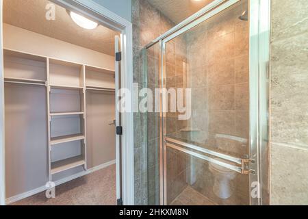 Walk-in closet with shelving units near the shower stall Stock Photo