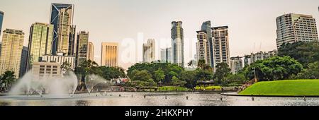 Kuala Lumpur, Malaysia, November 18, 2018: Fountain on the lake in the evening, near by Twin Towers with city on background. Kuala Lumpur, Malaysia Stock Photo