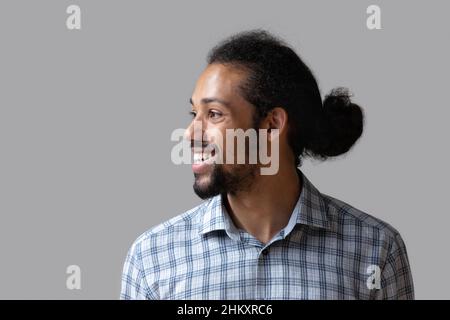 Dreamy happy young African American man looking in distance. Stock Photo