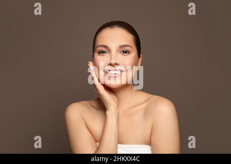 Happy woman with healthy clean skin portrait. Facial treatment, skincare, cosmetology, beauty and spa concept. Stock Photo