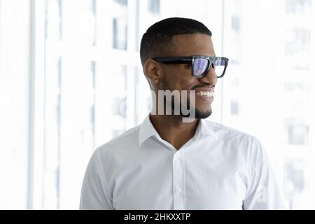 Happy young millennial Black businessman in formal shirt and glasses Stock Photo