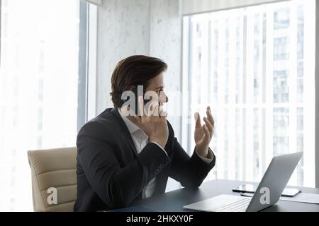 Happy business leader, executive talking on mobile phone at workplace Stock Photo