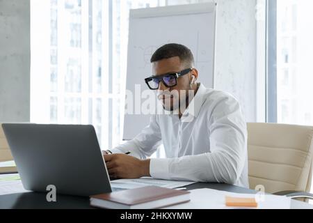 African business professional man with wireless earphone making video call Stock Photo