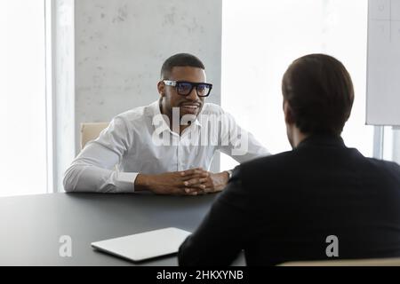 Happy confident African business leader meeting with employee Stock Photo