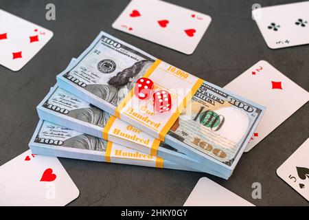 Money cards and poker dice on a table in a casino, symbolizing win or loss Stock Photo