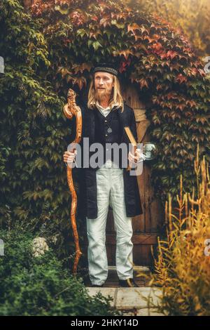 Alchemist in a beautiful ornamental dress in nature. Stock Photo