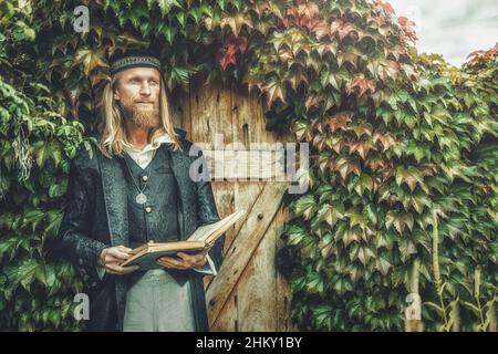 Alchemist in a beautiful ornamental dress in nature. Stock Photo