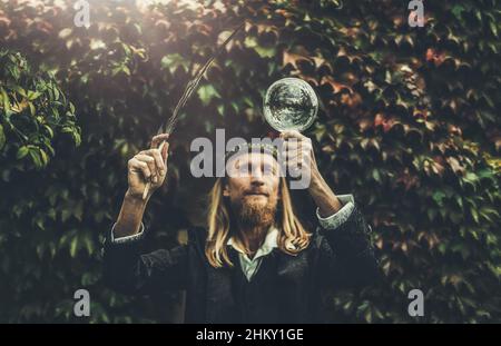 Alchemist in a beautiful ornamental dress in nature. Stock Photo