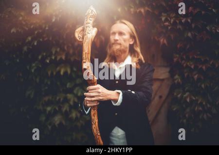 Alchemist in a beautiful ornamental dress in nature. Stock Photo