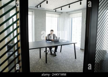 Business man, leader working at laptop in office candid shot Stock Photo
