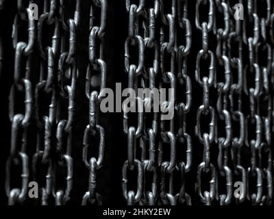 Chain background. Abstract high contrast old grunge texture chains wall, dark background, black and white style. Stock Photo