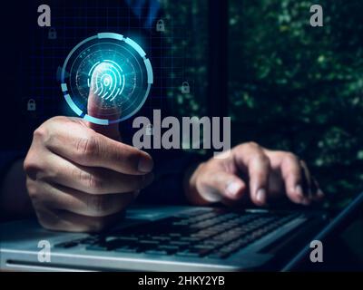 Cyber security and verification identity concepts. Businessman scans his thumb, biometric fingerprint scanning on futuristic hologram virtual screen w Stock Photo