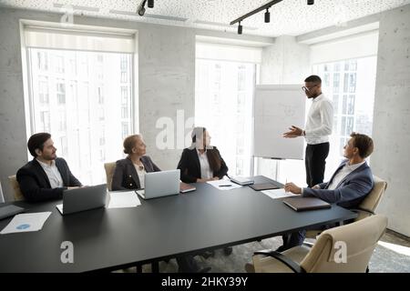 Confident African American business team leader speaking before audience Stock Photo