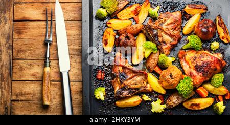 Grilled chicken meat with vegetables. Roasted meat on baking sheet Stock Photo